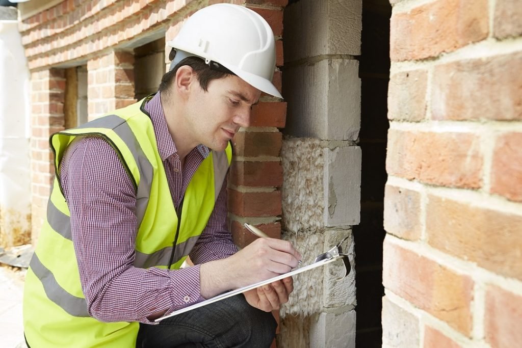Home Inspector Checking Insulation During House Inspection
